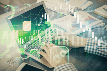 Double exposure of forex graph with man working on computer on background. Concept of market...