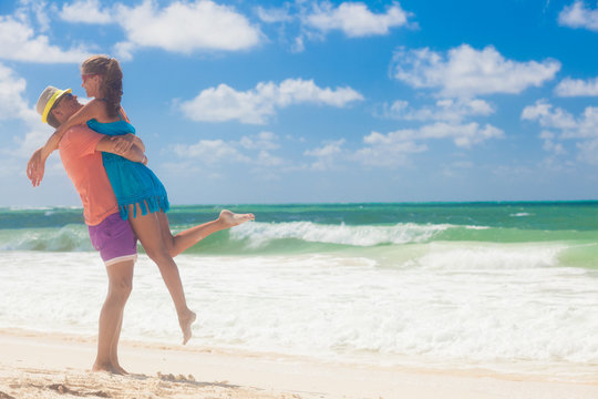 Beach couple walking on romantic travel honeymoon vacation summer holidays romance. Young happy lovers, Cayo Largo, Cuba