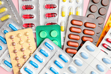 Different pills in blister packs as background
