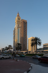 Fototapeta na wymiar DUBAI, UAE - may 2019: Skyscrapers lining Sheikh Zayed Road. In the foreground is Al Yaqoub Tower, which was inspired by Londons famous clock tower that houses Big Ben.