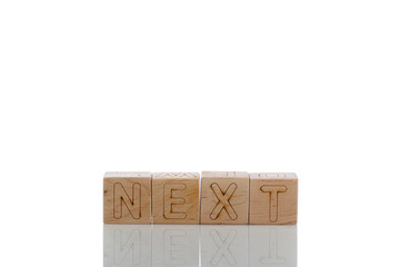 Wooden cubes with letters next on a white background