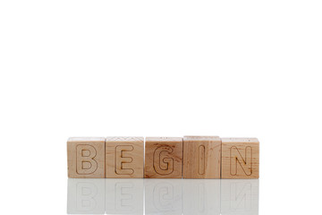 Wooden cubes with letters begin on a white background