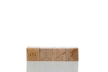 Wooden cubes with letters walk on a white background