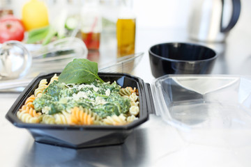 Catering, food out of the box. Appetizing pasta with spinach and cream cheese sauce.