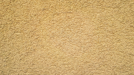 Beautiful textured plaster on the wall. Yellow green abstract background. Beautiful yellow textured stucco on the wall.