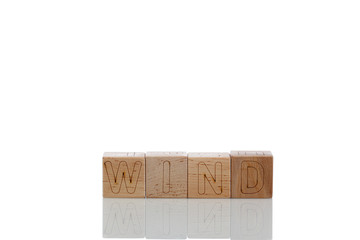 Wooden cubes with letters wind on a white background
