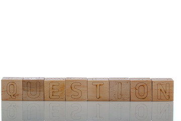 Wooden cubes with letters question on a white background