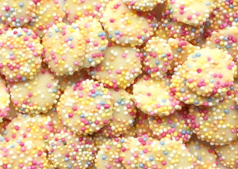 A close up photograph of jazzie sweets, white chocolate and hundreds and thousands. 