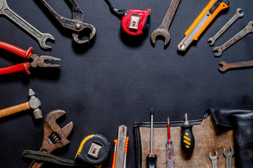 Tools for repair and reconstruction in home conditions lie on a black background