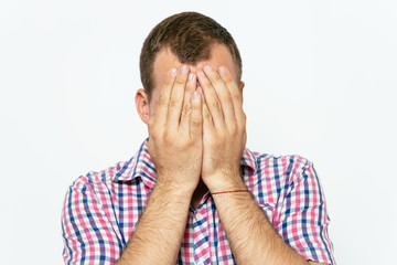 Man covering his face