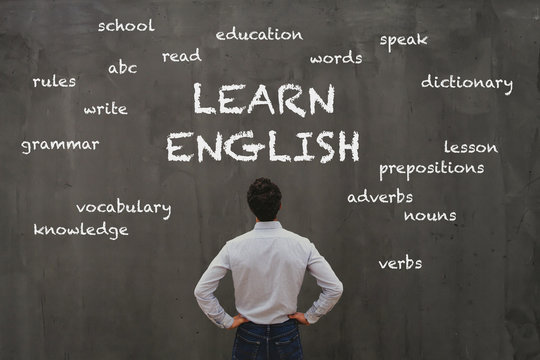 Learn English Concept, Business Man Looking At Word Cloud On Chalk Board