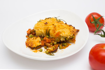 Cottage (shepherd) pie in dish on white background from close up