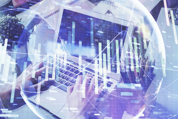 Double exposure of businessman working on laptop on background. International business hologram in front. Concept of success.