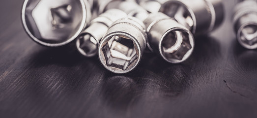 Socket wrenches isolated on wooden background
