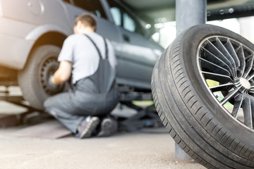 Car wheel repair shop outdoor ground . Seasonal winter tyre change at workshop. Vehicle tire...