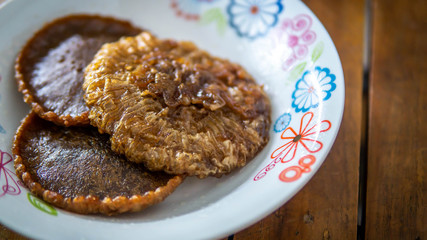 Close up view of Cucur Jawa or Cucur Topi, a traditional Malay food in a white plate.
