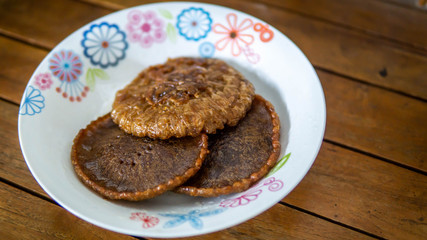 Close up view of Cucur Jawa or Cucur Topi, a traditional Malay food in a white plate.