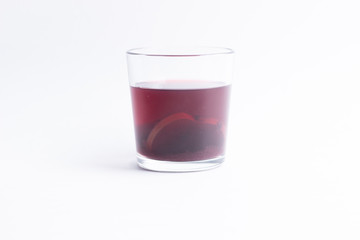 Compote made of dry apple slices and black currant on white background
