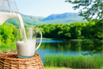 A glass of fresh milk on a natural background