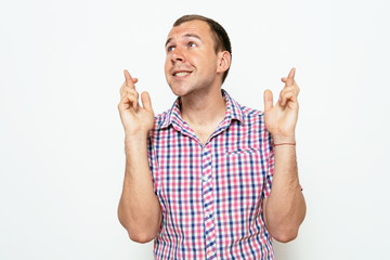 man crosses his fingers. Good luck, hope
