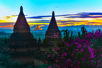 Shwezigon Pagoda Bagan Myanmar framed by Bell-shaped pagodas after sunset