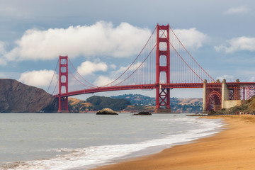 Golden Gate Bridge at sunset from sandy beach, San Francisco, California.