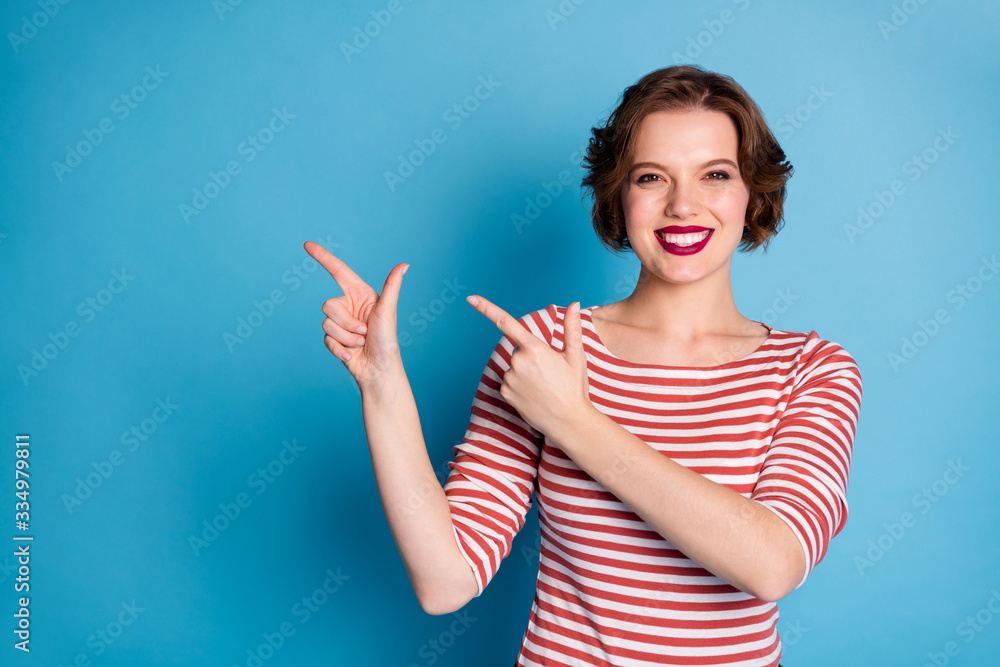 Canvas Prints Photo of beautiful pretty cheerful lady indicate fingers empty space presenting cool low sale prices wear casual red white shirt isolated bright blue color background