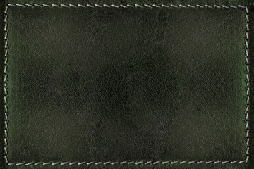 Green leather background with seams