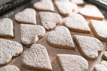 Fototapeta na wymiar freshly baked heart-shaped cookies prepared on Mother's Day. Sugar, Cinnamon, and lots of love