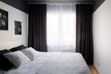 Stylish bedroom with big window