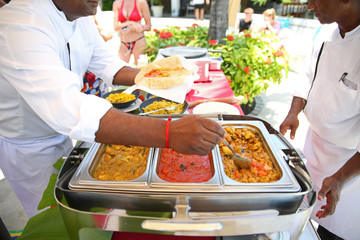 chef seasoning curry dish, ready to serve