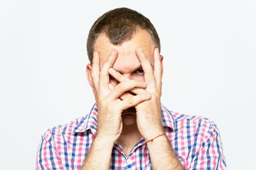 Man covering his face