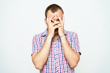 Man covering his face