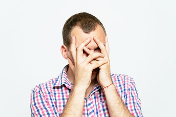 Man covering his face