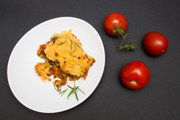 Shepherd, cottage pie dish on black background. Top view
