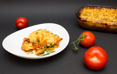 Shepherd, cottage pie dish on black background