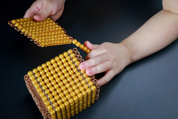 gold material Montessori bank exchange of a number from ten units per one ten ten tens per one...
