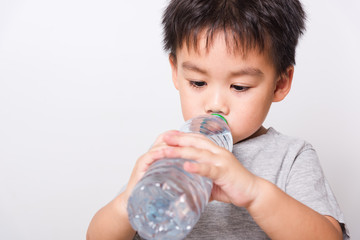 Closeup Asian face, Little children boy drinking water from Plastic bottle