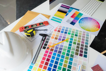 Engineers and creative artists work on table, work, consult, advise on choosing colors and materials, measuring size, choosing cool colors, soft tones, beautiful tones.
