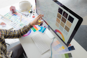 Engineers and creative artists work on table, work, consult, advise on choosing colors and...