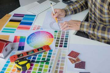 Engineers and creative artists work on table, work, consult, advise on choosing colors and materials, measuring size, choosing cool colors, soft tones, beautiful tones.
