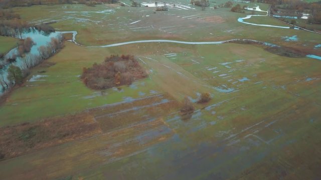 Blue Autumn Swampy River. Swampy Landscape Matica River. Aerial Footage of a Swampy River and Green Flooded Fields From a Bird's Eye View. Rijeka Matica kod Luznice Komani