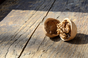 Walnut and half shell on a wooden board. The concept is to open your mind, to be open to the world.