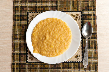 Yellow pea puree in a white plate