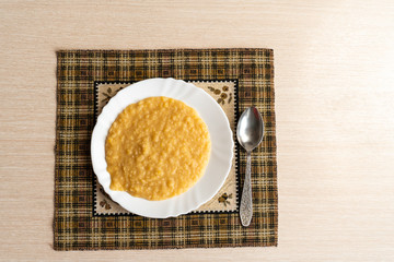 Yellow pea puree in a white plate