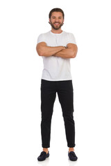 Fototapeta premium Happy Handsome Man Is Standing With Arms Crossed. Front View.