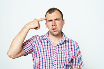 Closeup portrait of angry man gesturing with his finger against his temple, are you crazy?