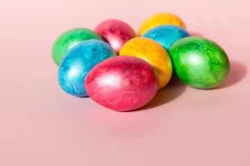 Colorful easter eggs on pink background. Happy Easter composition. Copy space.