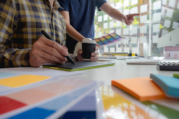 Fototapeta premium Engineers and creative artists work on table, work, consult, advise on choosing colors and materials, measuring size, choosing cool colors, soft tones, beautiful tones.