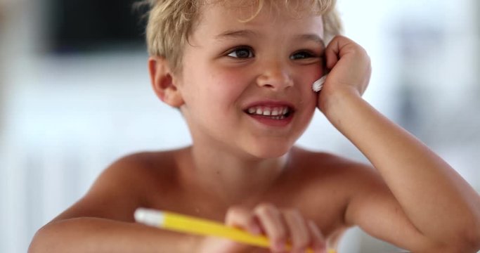 Cute bashful shy toddler boy face being adorable
